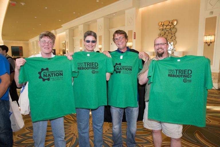 Milena and three other IT professionals at Connectwise’s Automation Nation conference holding up green shirts.